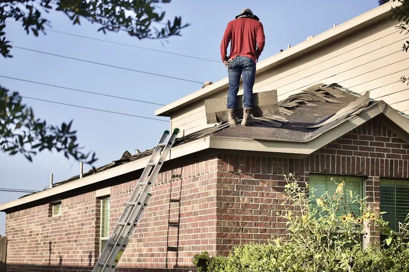 Professional roofer working on a residential roof in Salem Woods